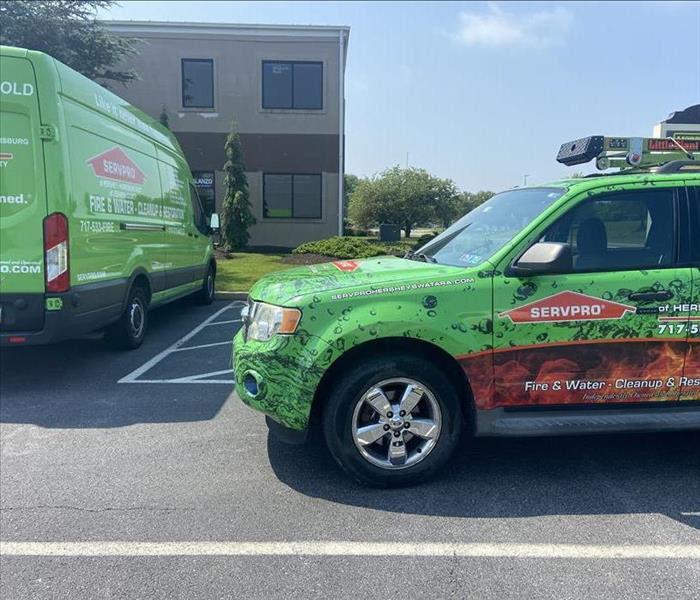 SERVPRO vehicles parked in front of a house