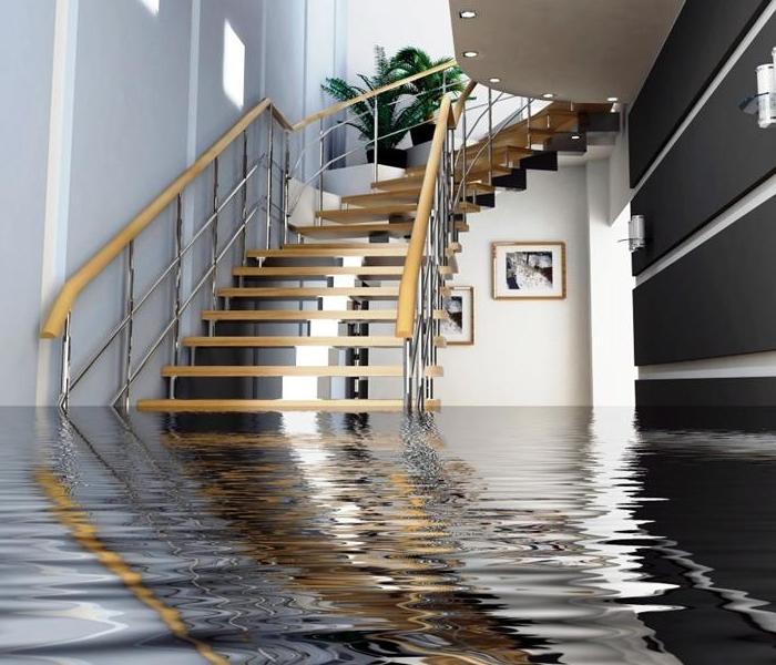 Spiral staircase leading down to a flooded living room
