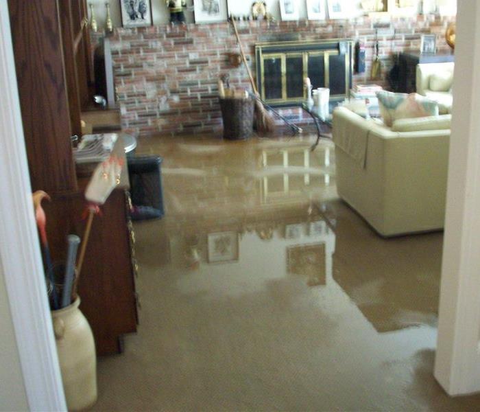 flooded living room area with fire place and furniture