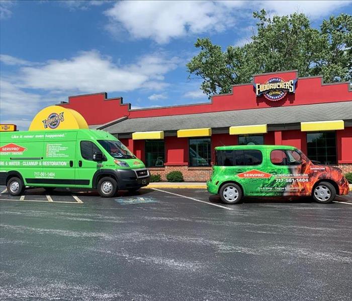 SERVPRO vehicles parked outside of a Fudruckers Restaurant