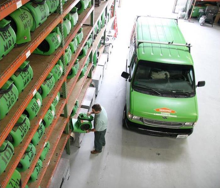 < img src =”warehouse.jpg” alt = “a green SERVPRO van parked in a warehouse full of equipment" >