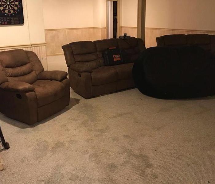 finished basement with carpet and furniture