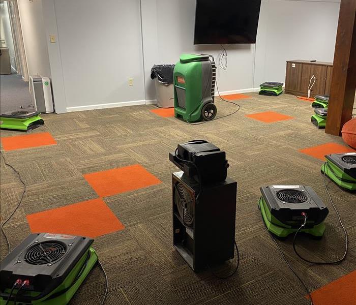 Dehumidifiers and Air Movers drying out carpet